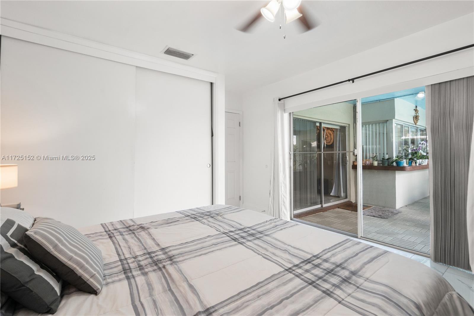 7271 Sunset Strip Sunrise, FL 33313 - Photo 32 of 45 a bedroom with a bed and a chandelier