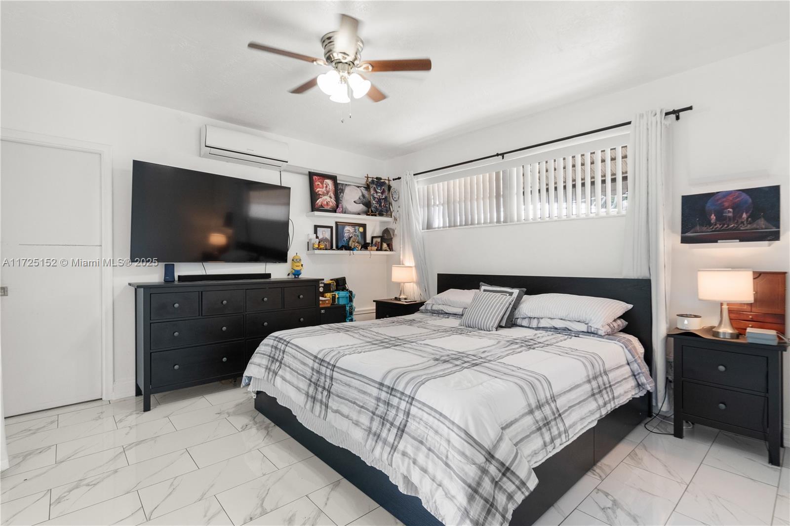 7271 Sunset Strip Sunrise, FL 33313 - Photo 33 of 45 a spacious bedroom with a bed and a flat screen tv