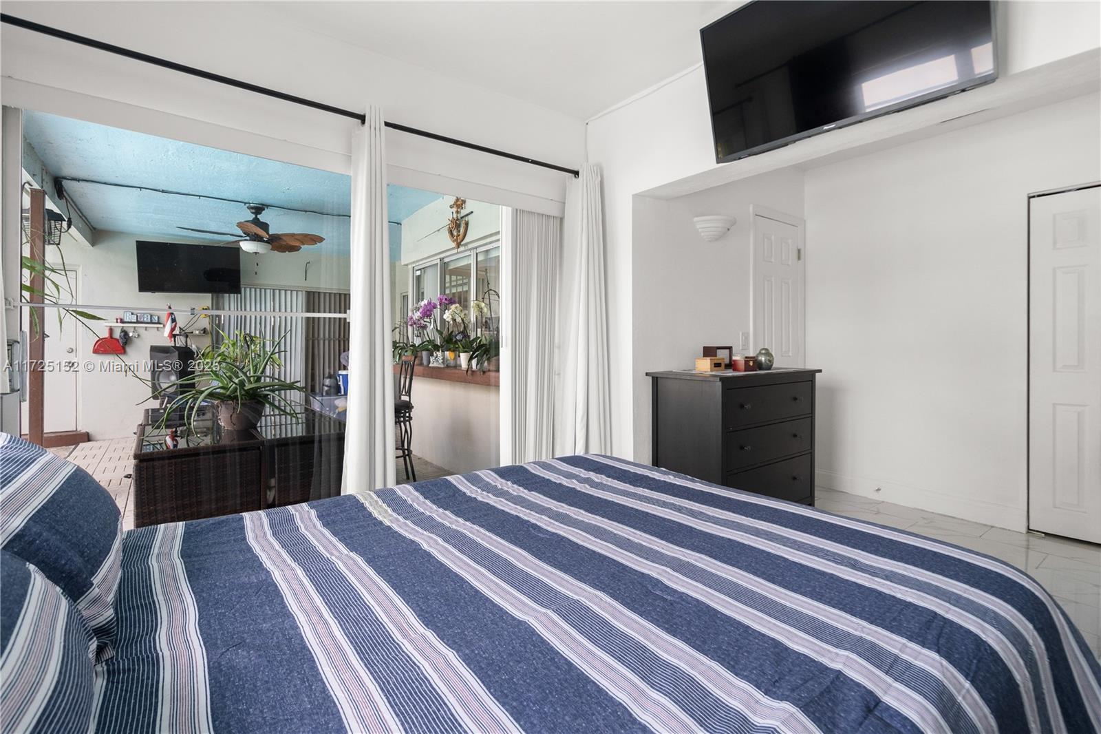 7271 Sunset Strip Sunrise, FL 33313 - Photo 34 of 45 a bedroom with a bed and a large mirror
