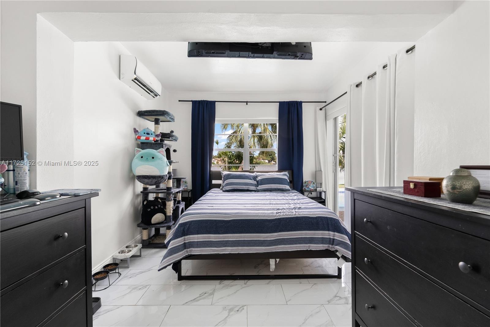 7271 Sunset Strip Sunrise, FL 33313 - Photo 36 of 45 a spacious bedroom with a bed and a chandelier