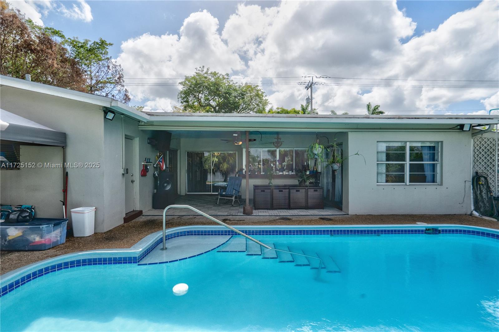 7271 Sunset Strip Sunrise, FL 33313 - Photo 40 of 45 a view of a backyard with a patio and fire pit