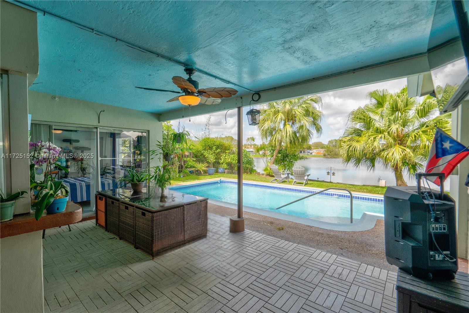 7271 Sunset Strip Sunrise, FL 33313 - Photo 44 of 45 a living room with patio furniture and a floor to ceiling window