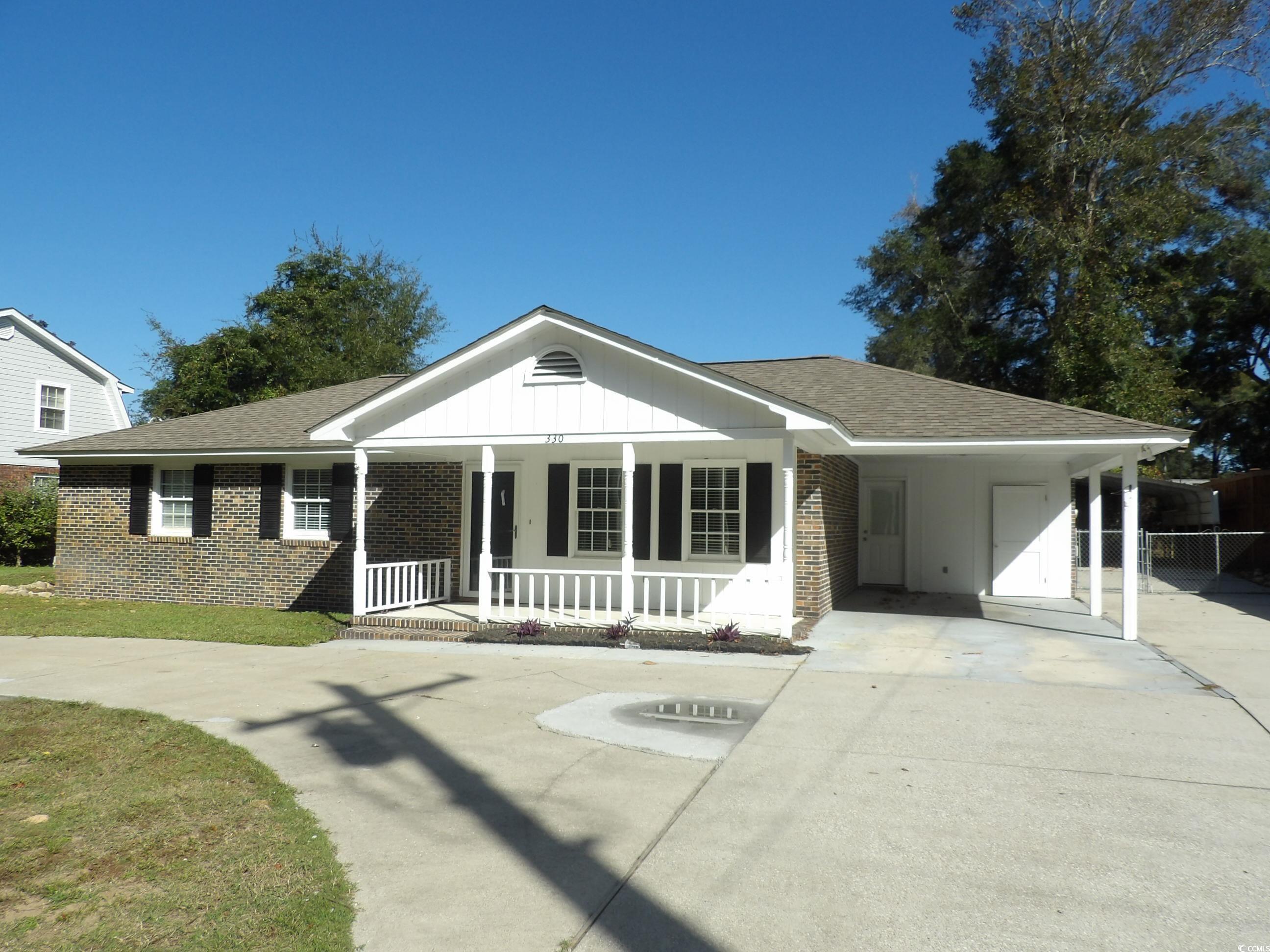 330 Stanley Drive Murrells Inlet, SC 29576 - Photo 1 of 32 View of front of house with covered porch and a ca