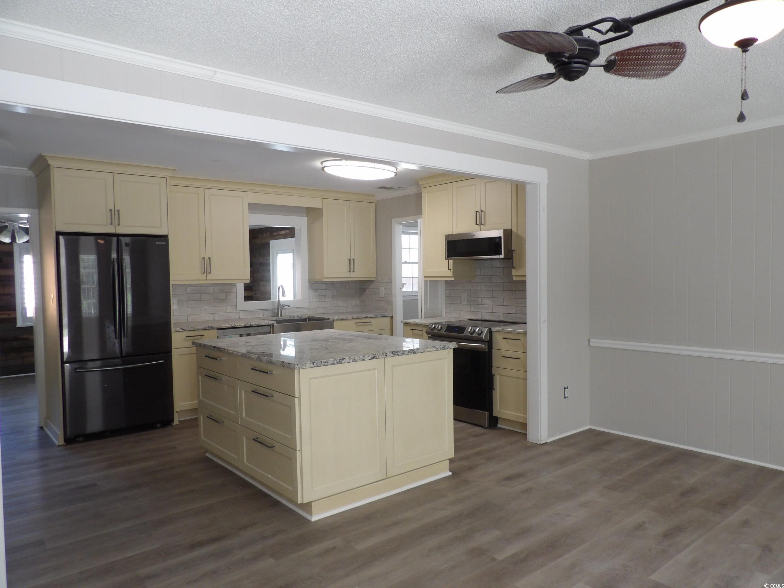 330 Stanley Drive Murrells Inlet, SC 29576 - Photo 9 of 32 Kitchen with cream cabinetry, dark hardwood / wood