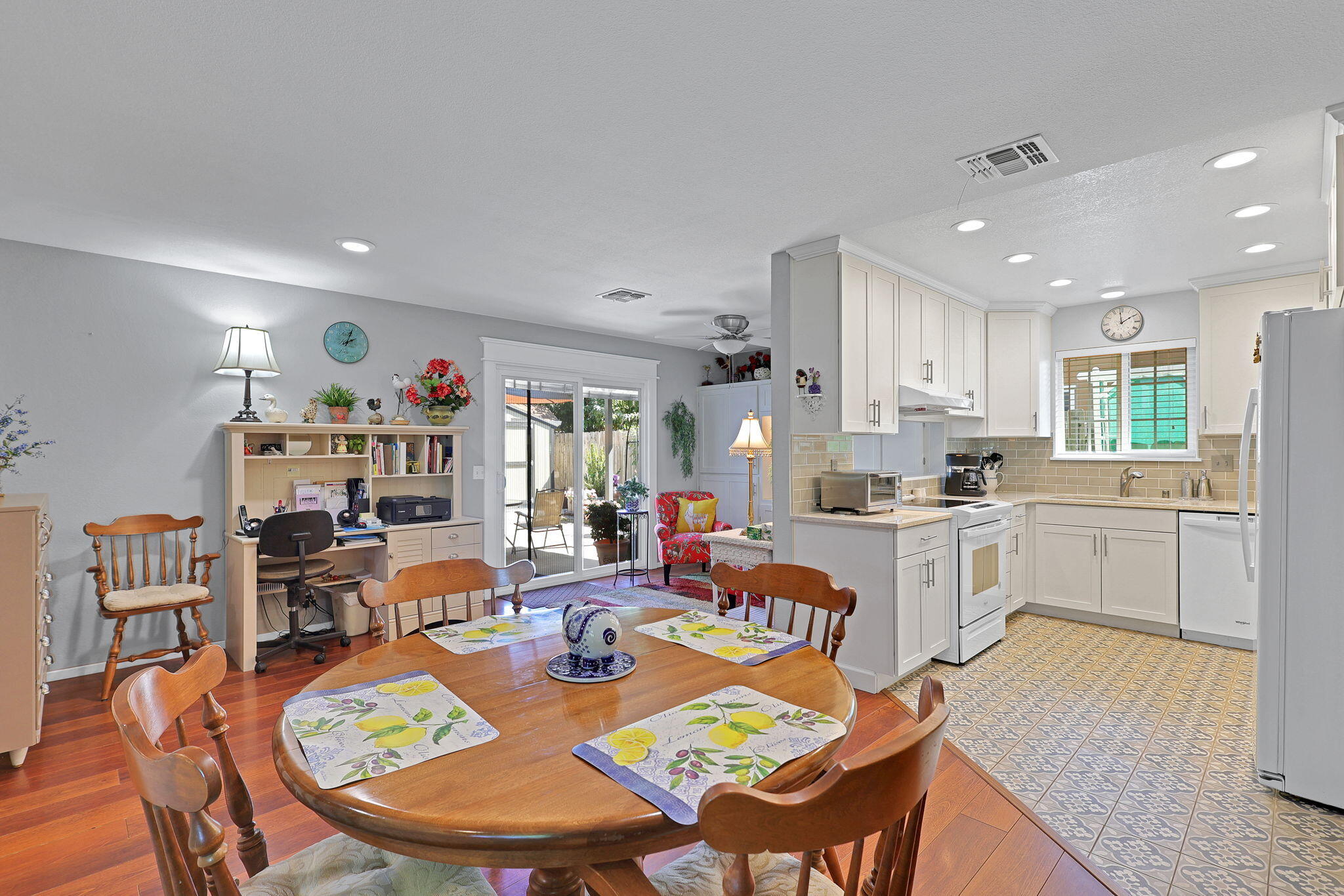 7022 Marvin Trail Redding, CA 96001 - Photo 12 of 27 a open dining room with stainless steel appliances kitchen island granite countertop a dining table chairs and a refrigerator