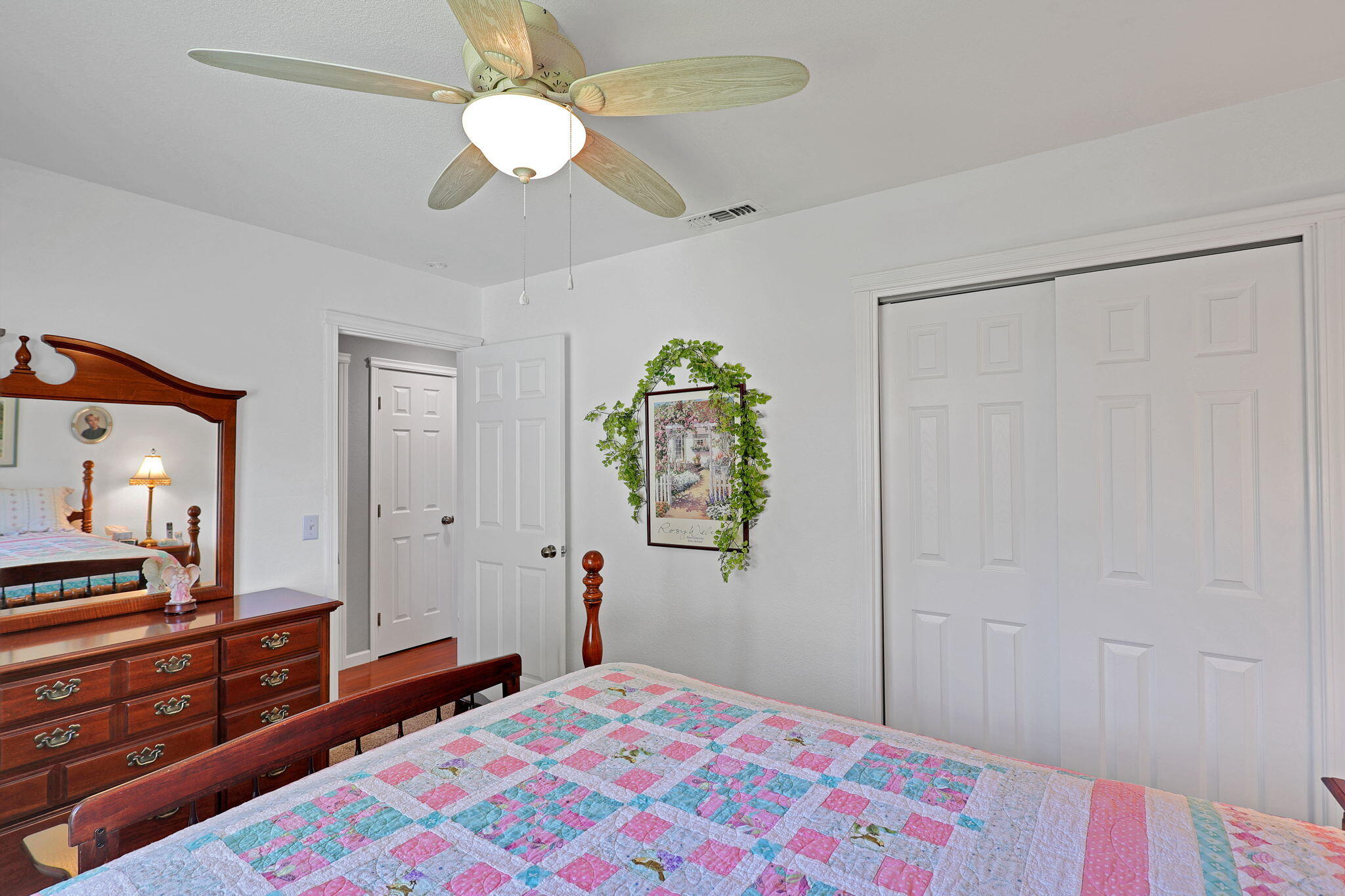 7022 Marvin Trail Redding, CA 96001 - Photo 18 of 27 a bedroom with a bed and a chandelier