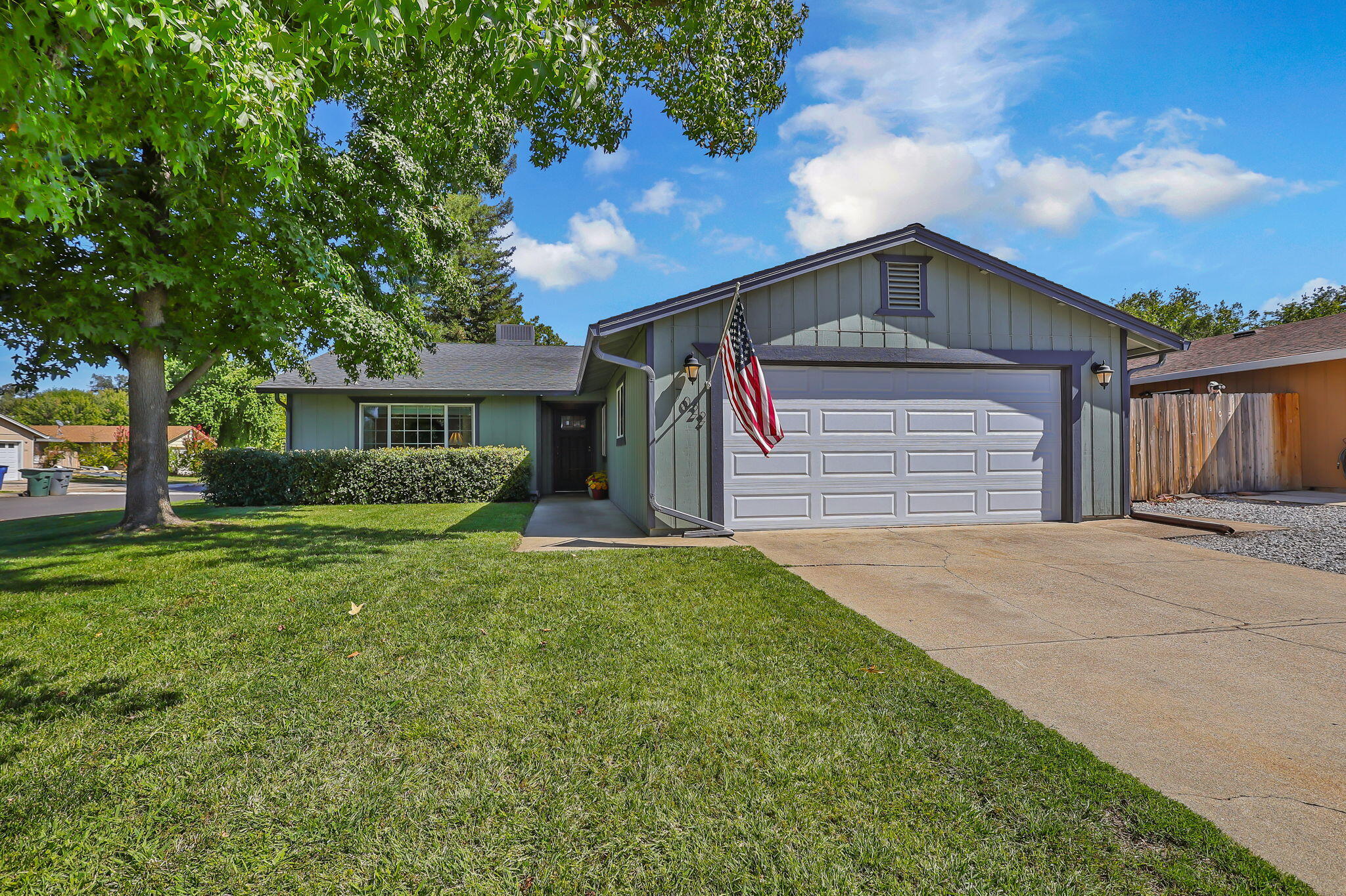 7022 Marvin Trail Redding, CA 96001 - Photo 2 of 27 a front view of a house with a yard and garage