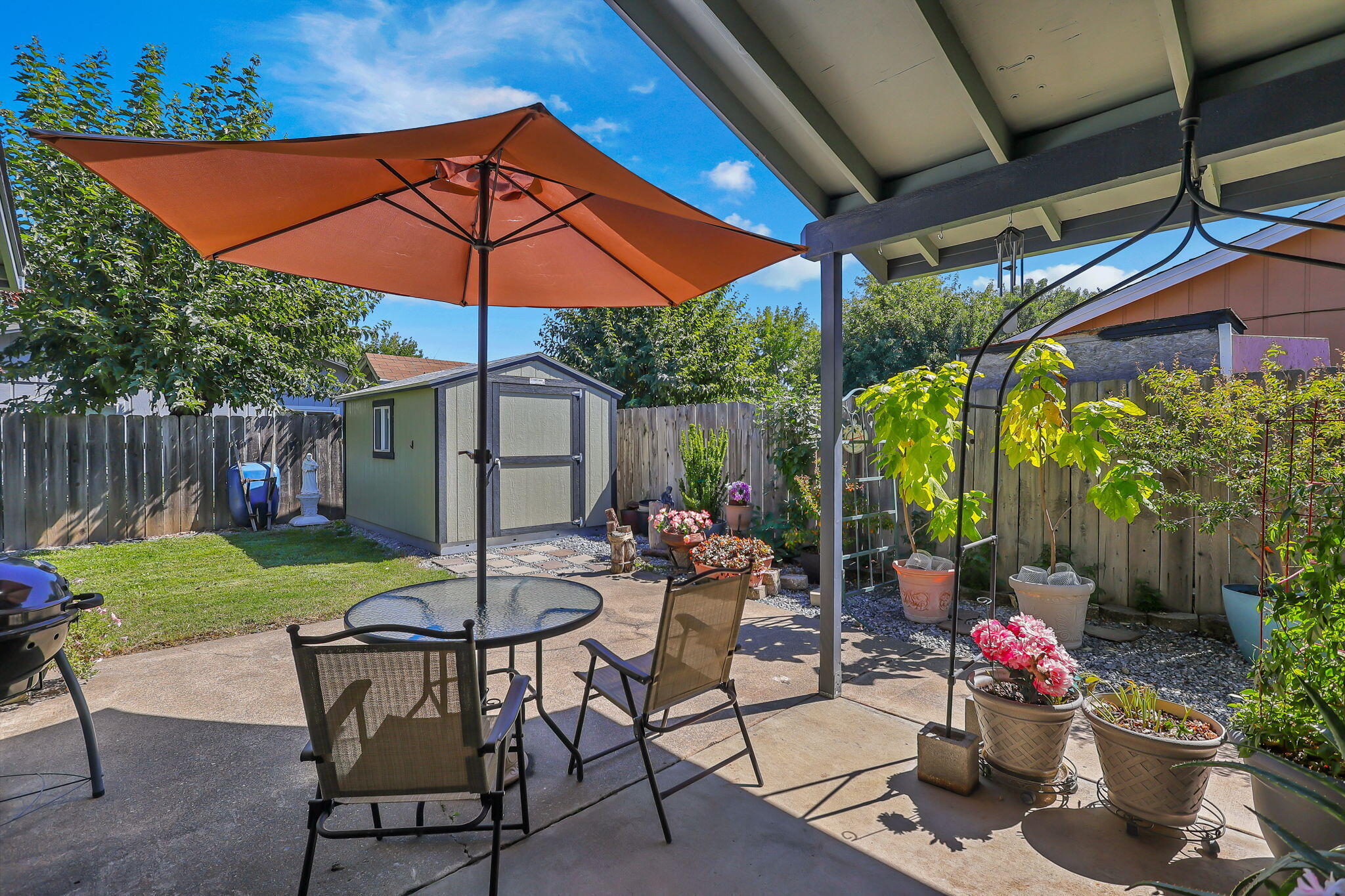 7022 Marvin Trail Redding, CA 96001 - Photo 22 of 27 a patio with a patio table and chairs