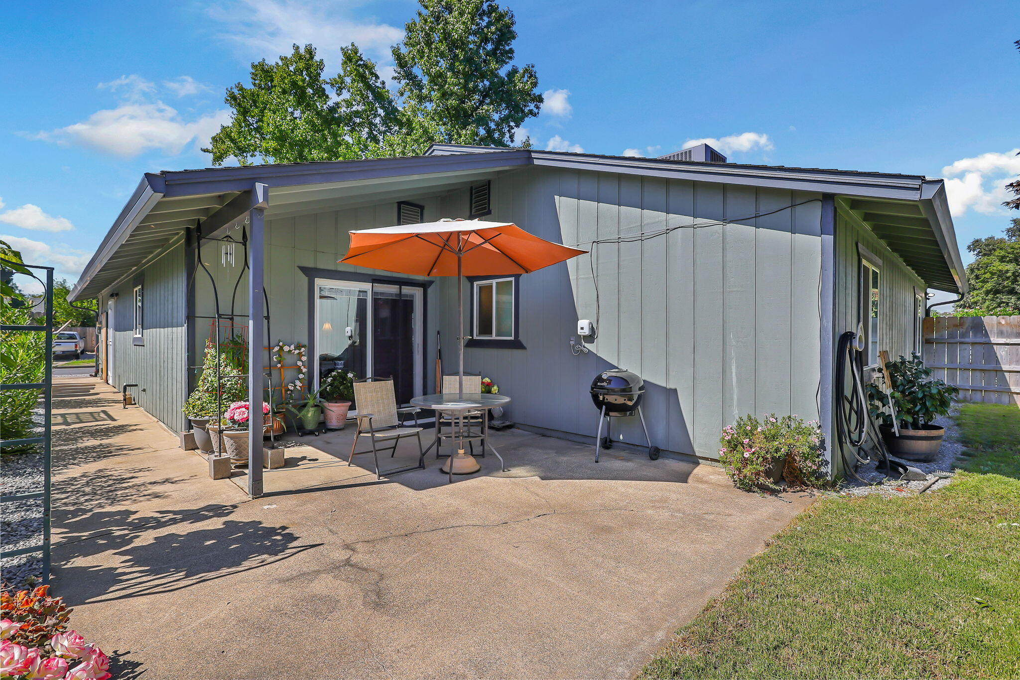 7022 Marvin Trail Redding, CA 96001 - Photo 24 of 27 a view of a patio with a table and chairs under an umbrella