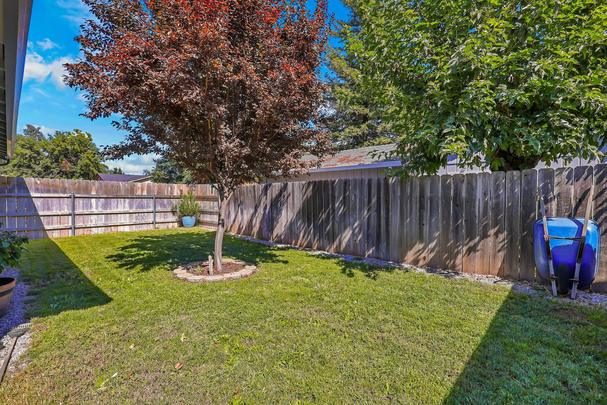7022 Marvin Trail Redding, CA 96001 - Photo 26 of 27 a view of a backyard with table and chairs wooden fence