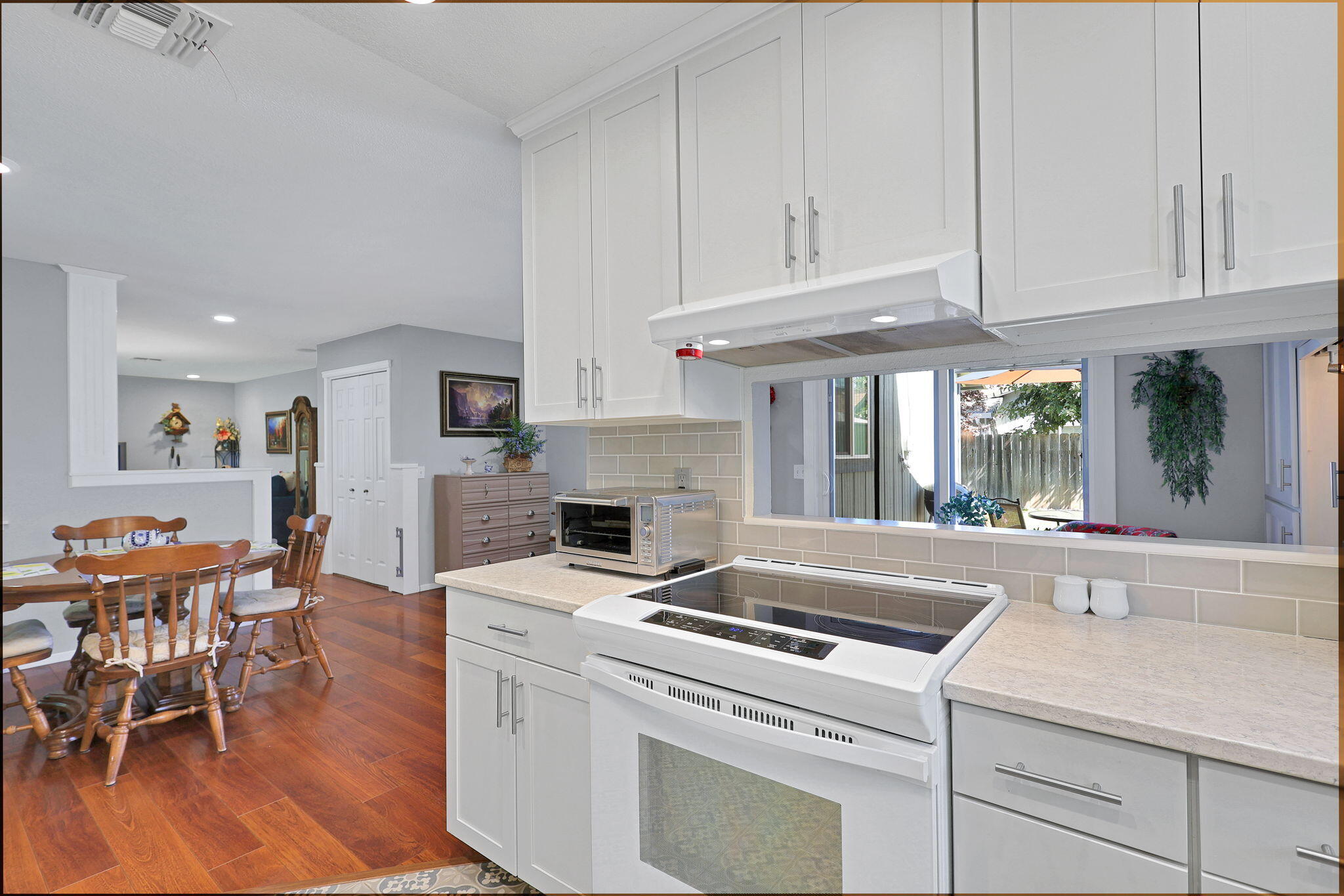 7022 Marvin Trail Redding, CA 96001 - Photo 10 of 27 a kitchen with granite countertop white cabinets and white appliances