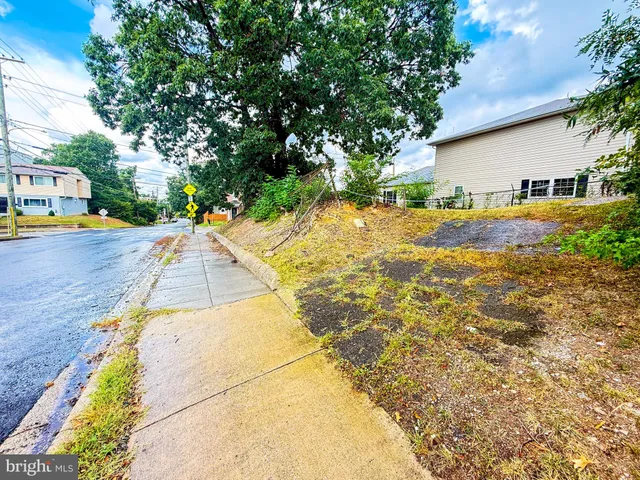 a view of swimming pool with outdoor seating and house in the background