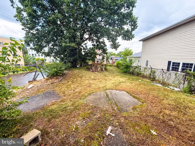 a view of backyard with swimming pool and seating space
