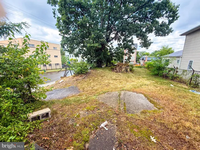 a view of backyard with swimming pool and seating space