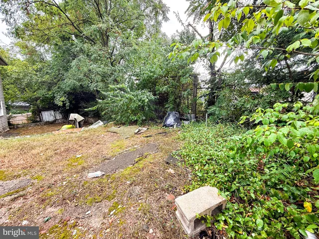 a view of yard with swimming pool and trees