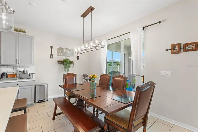 a dining room with furniture and chandelier