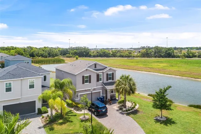 an aerial view of residential houses with outdoor space and ocean view