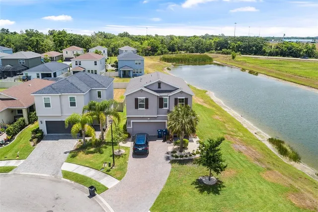 an aerial view of a house with a garden and swimming pool