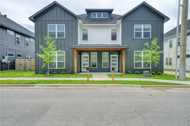a view of a house with a yard and a large window