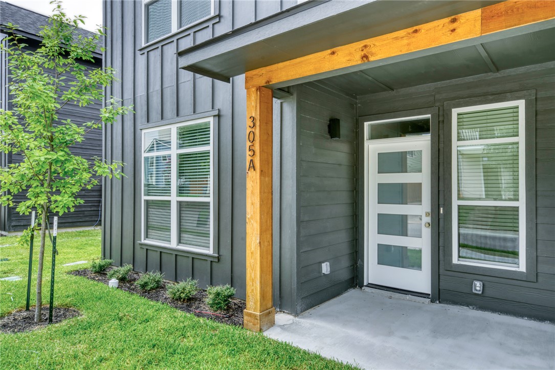305 Cooner Street, Unit A College Station, TX 77840 - Photo 2 of 35 a view of backyard with potted plants and floor to ceiling window
