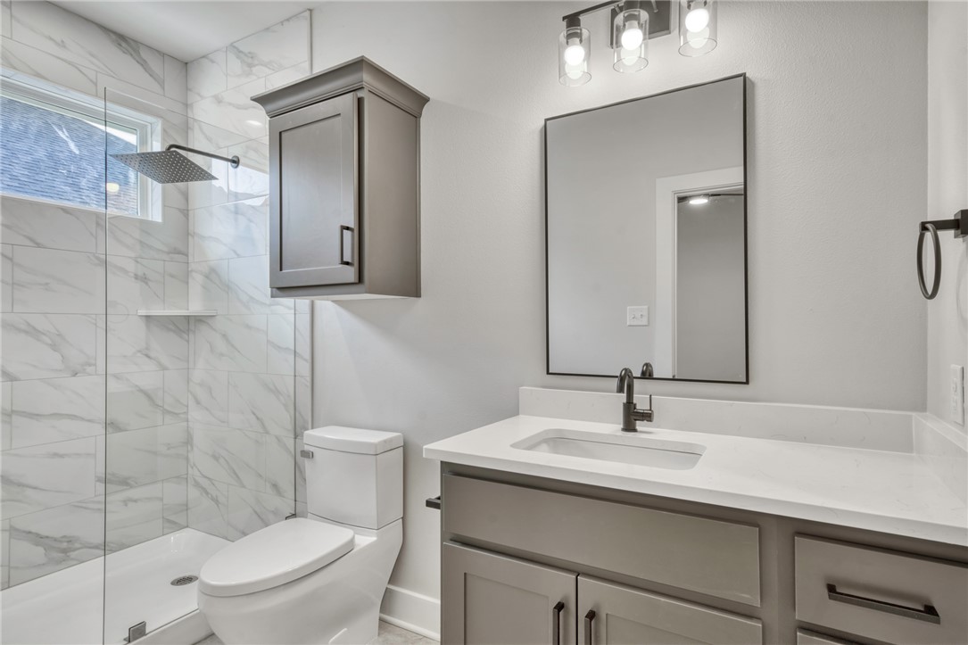 305 Cooner Street, Unit A College Station, TX 77840 - Photo 27 of 35 a bathroom with a toilet sink and mirror