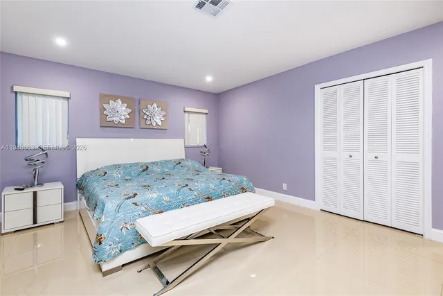 a room with a bed and paintings on the wall