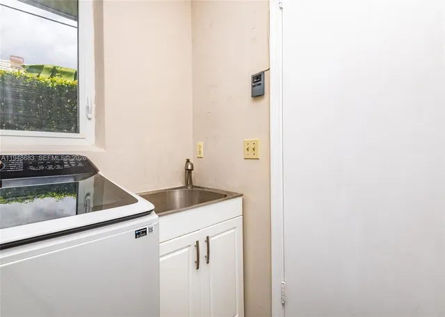 a kitchen with a sink and a window