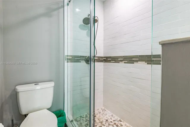 a bathroom with a toilet and a shower