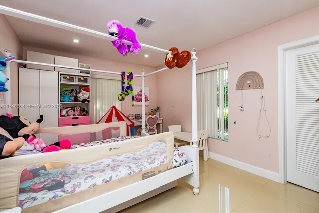 a bedroom with furniture and a baby crib