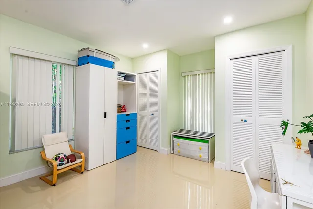 a bedroom with furniture and a window