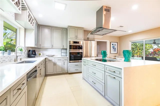 a kitchen with stainless steel appliances granite countertop a stove and cabinets