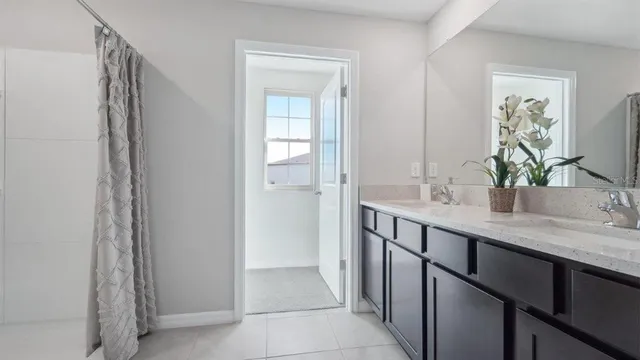 a bathroom with a double vanity sink and a mirror