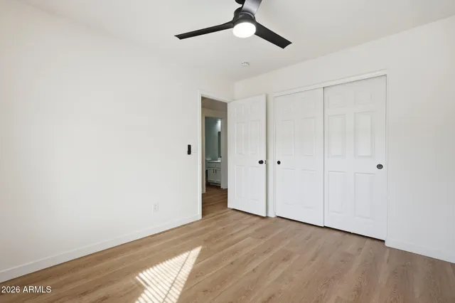 a view of empty room with wooden floor