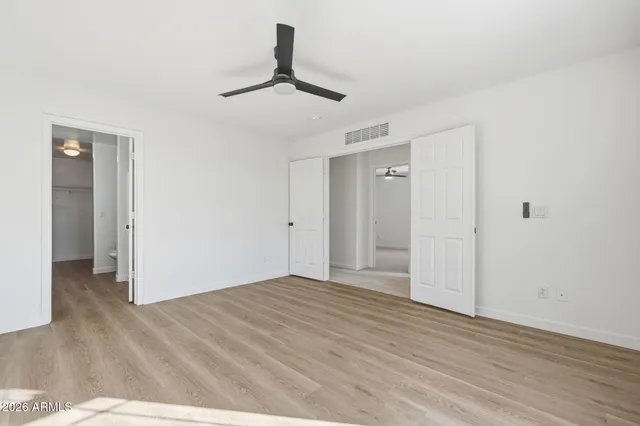 a view of empty room with wooden floor