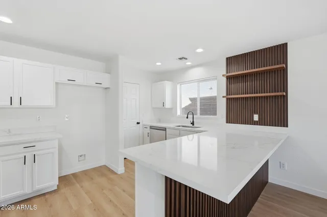 a kitchen with kitchen island a counter top space and cabinets