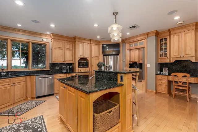 a dining room with furniture large windows and a chandelier