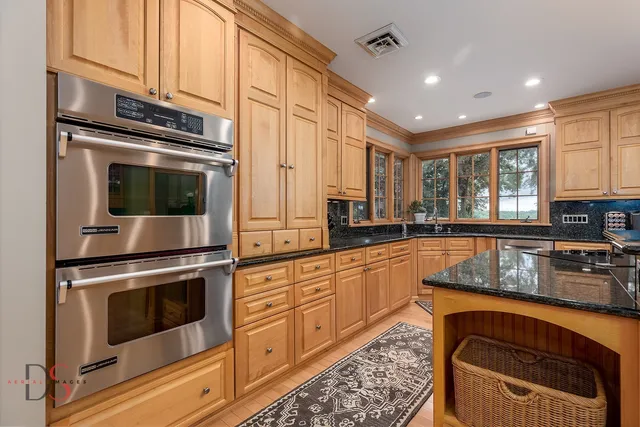 a kitchen with stainless steel appliances granite countertop a refrigerator and a sink