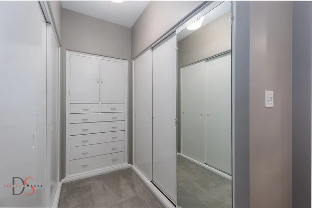 a bedroom with a bed and a book shelf