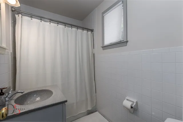 a room with pool table and windows