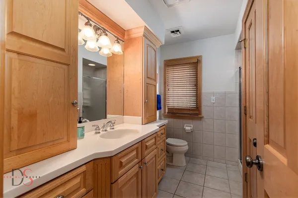 a view of a yard with plants and a bench