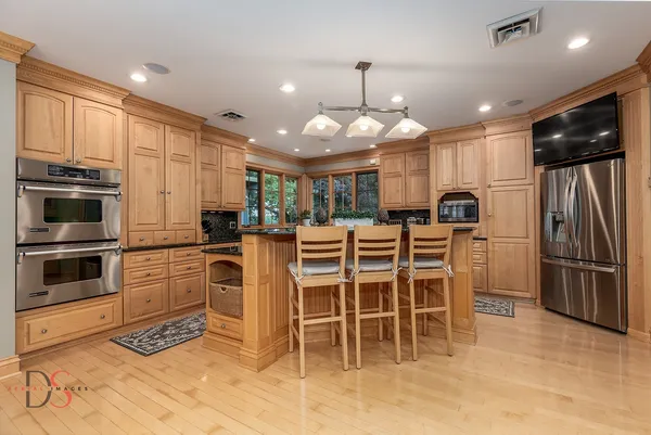 a kitchen with stainless steel appliances granite countertop a stove microwave and cabinets