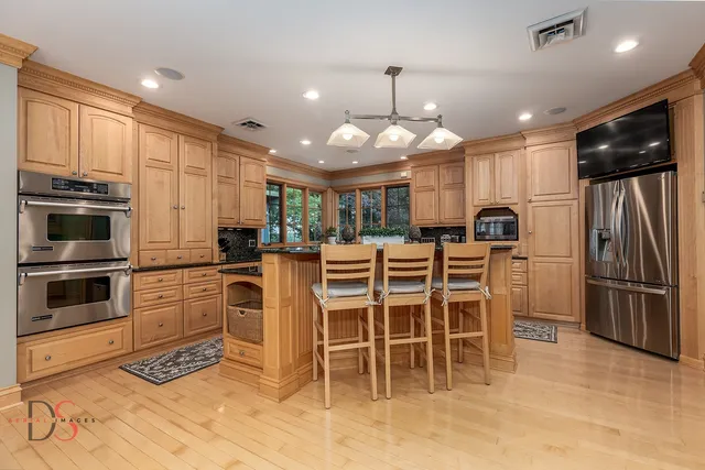 a kitchen with stainless steel appliances granite countertop a stove microwave and cabinets