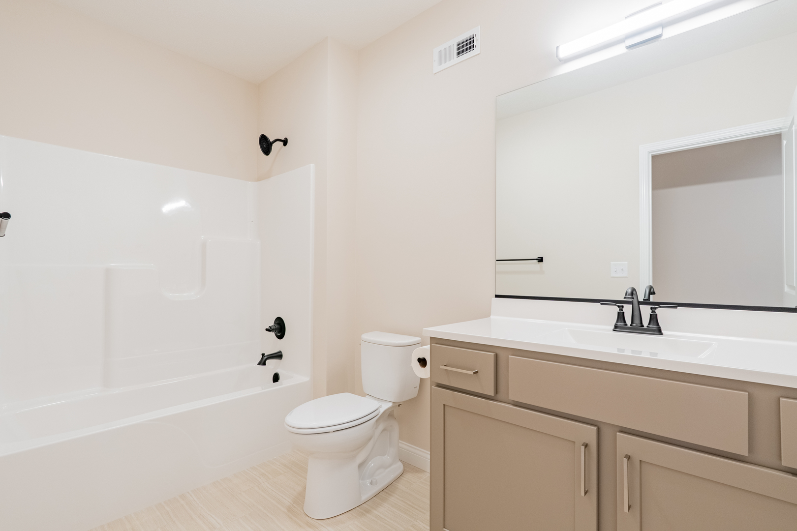 1906 Dunraven Road Bloomington, IL 61704 - Photo 21 of 28 a bathroom with a sink a toilet and shower