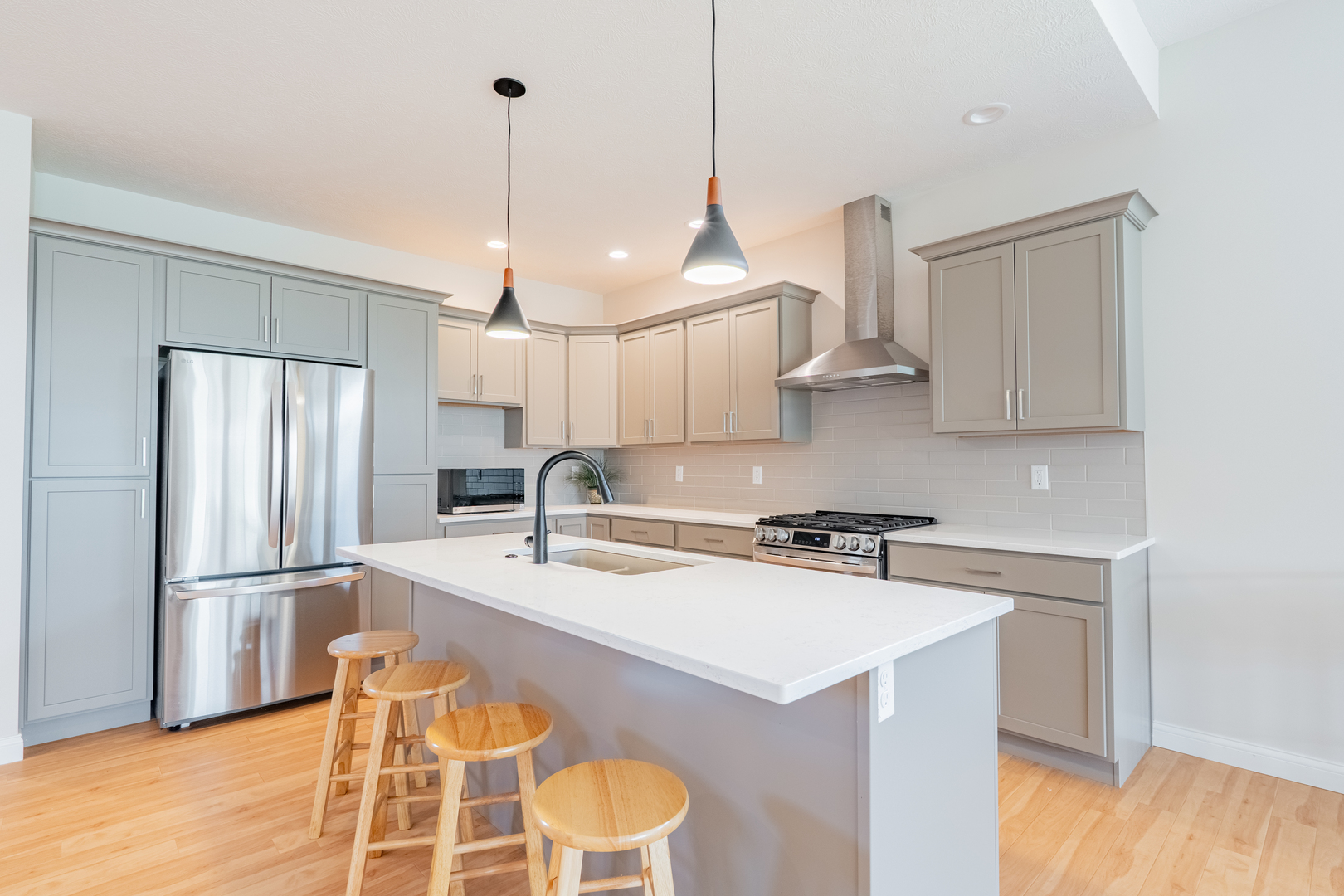 1906 Dunraven Road Bloomington, IL 61704 - Photo 5 of 28 a kitchen with stainless steel appliances granite countertop a sink a stove a refrigerator a center island and cabinets