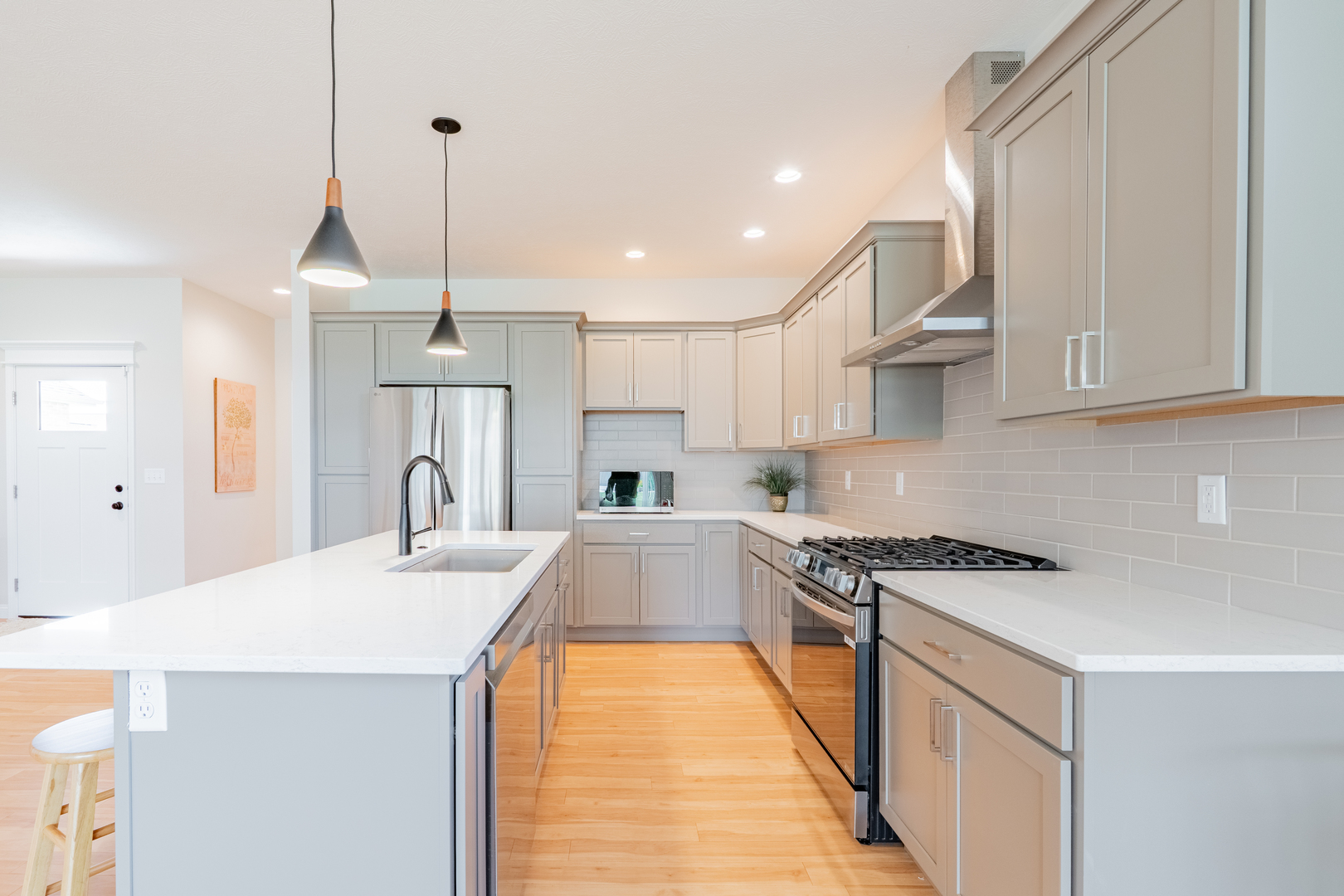 1906 Dunraven Road Bloomington, IL 61704 - Photo 6 of 28 a kitchen with stainless steel appliances a sink a stove a refrigerator a center island and cabinets