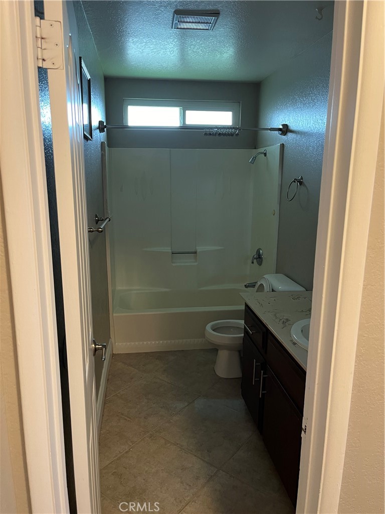 19260 Santa Rosa Mine Road Perris, CA 92570 - Photo 13 of 22 a bathroom with a granite countertop sink toilet and shower