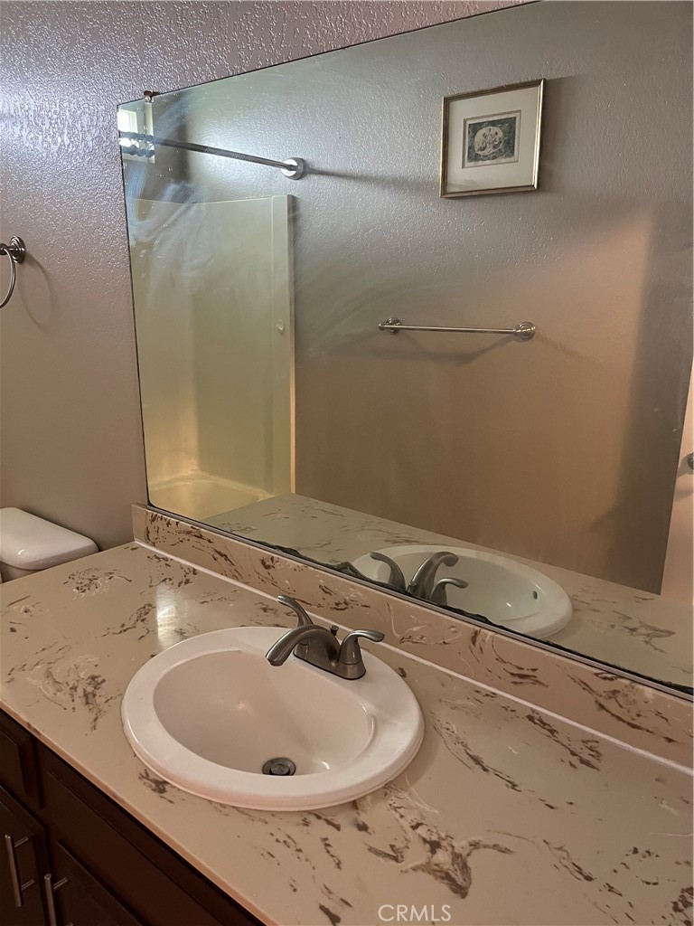 19260 Santa Rosa Mine Road Perris, CA 92570 - Photo 14 of 22 a bathroom with a sink and a mirror