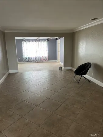 a view of empty room with window and fireplace