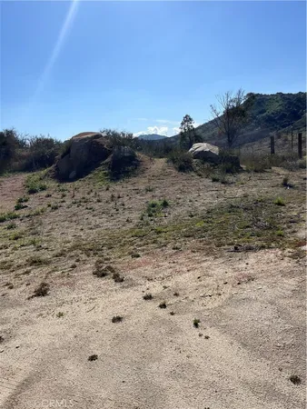 a view of a dry field with lots of bushes