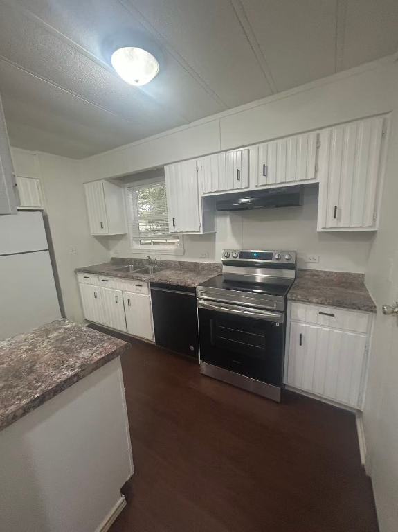23393 Nameless Road, Unit 123 Leander, TX 78641 - Photo 14 of 15 a kitchen with granite countertop a sink stainless steel appliances and cabinets